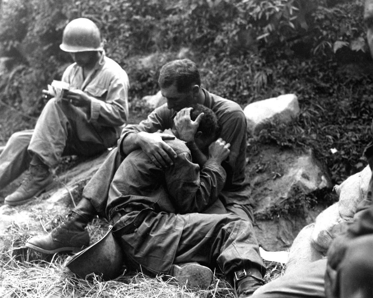 U.S. soldier comforting a grief stricken infantryman