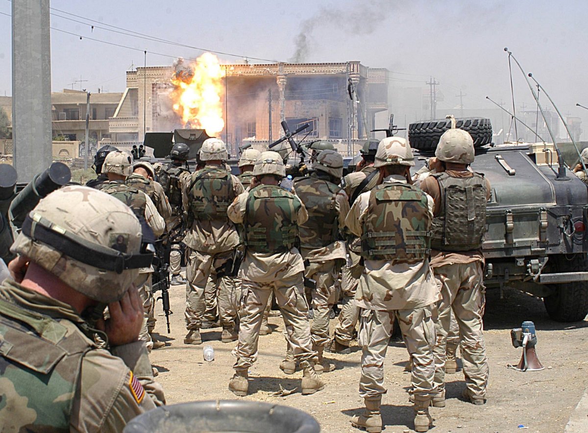 U.S. soldiers watch as a TOW missile strikes the location of Uday and Qusay Hussein