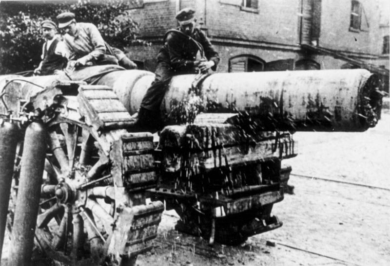 Workmen decommissioning a heavy gun, to comply with the treaty