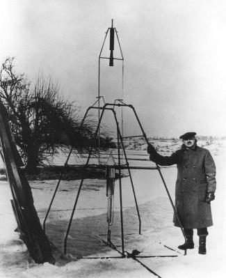 Goddard next to the first liquid-fueled rocket