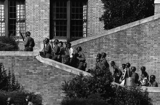 Soldiers from the 101st Airborne escort the black students into Central High School in Little Rock