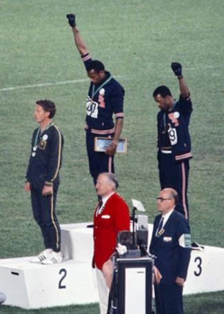 Smith (center) and Carlos with fists raised in protest
